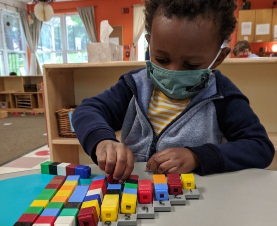 Child playing with unifix cubes