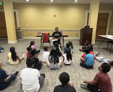 Teacher reading to students - Summer Reading program