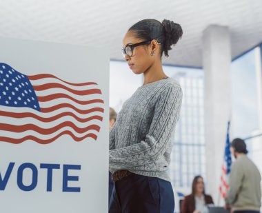 A woman casts a ballot. Photo by iStock