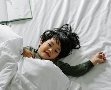 A child resting in bed.