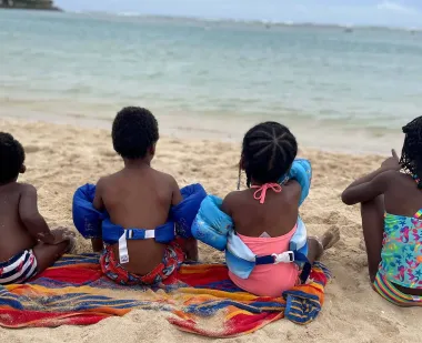 black children looking out to the ocean