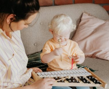 Mother and daughter playing with xylophone