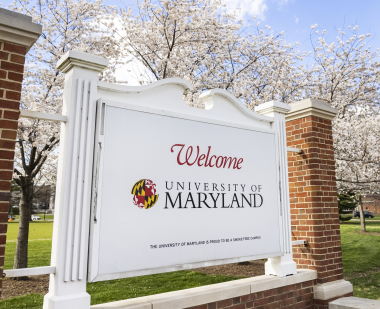 white sign that says 'welcome to the university of maryland'