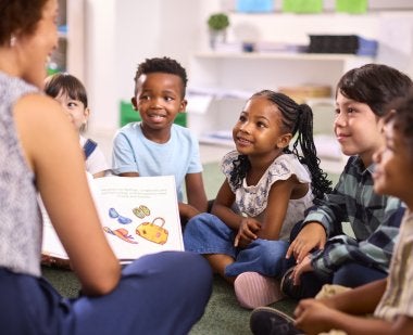 A teacher reads to students. 