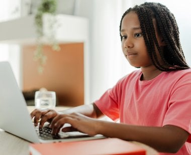 A Black girl using a laptop