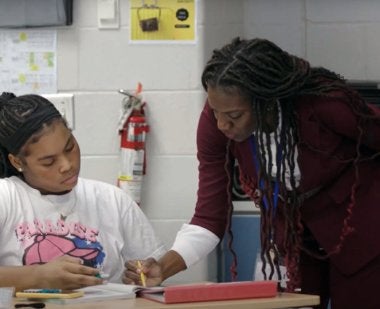 Teacher Mitchelle McLeod works with a student in her math class.