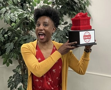 Dean Kimberly Griffin shows off the Testudo trophy, which the College of Education received for the fifth consecutive year in 2026 for winning the faculty/staff power hour on Giving Day.