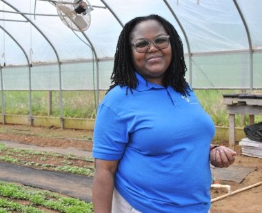 Truphena Choti Ph.D. '09, CEO of the nonprofit AfriThrive, stands inside a greenhouse in Dickerson, Md., where the organization grows indigenous African vegetables for the community.