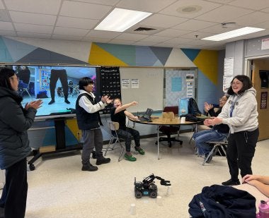 Students at A. Mario Loiederman Middle School cheer as they test the robot they built at the UMD-MCPS afterschool program Co-Learn Code and Mind.