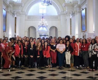 Students and faculty stand in the rotunda of the Maryland State House
