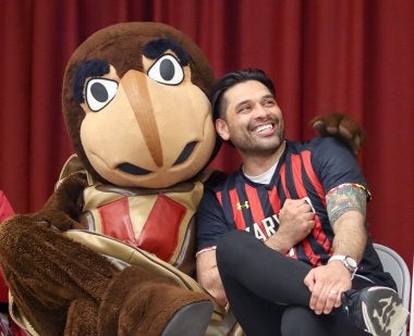 Testudo embraces P.E. teacher Sergio Cabrera ’14, M.Ed. ’17 during a surprise school visit for Teacher Appreciation Week.