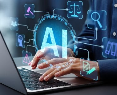 The letters "AI" and various symbols float in front of a photo of hands typing on a laptop.