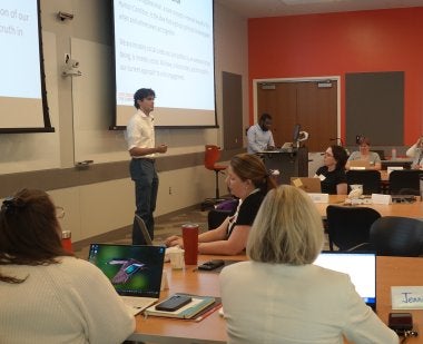 Anderson Harlor ’29 of TerpsVote speaks to a room full of instructors participating in the Civic Engagement Across the Curriculum professional development program.