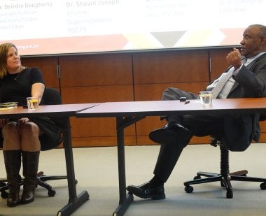 Deirdre Mayer Dougherty and Alvin Thornton sit together at a table and engage in conversation.