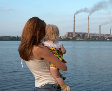Child looking at smoke stacks with mom