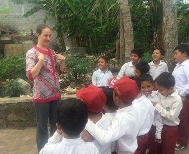 Tabitha Kidwell leads elementary students in Indonesia in an English exercise
