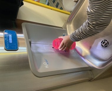 Child filling waterbottle