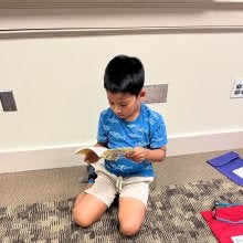 Young Boy Reading book - Summer Reading program