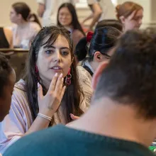 Aviva Orange ’27 signs with fellow students at UMD's signing dinner.