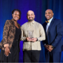 Mark López posed with award