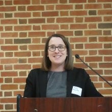 Molly Reynolds, vice president and director of Governance Studies at the Brookings Institution, speaks at a podium at the "Who Has the Power? The Constitution and Our Role in Securing Democracy” event.