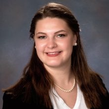 headshot of Beatrice Hammett in a white shirt and black blazer