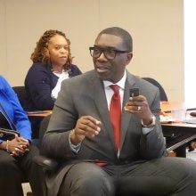 Shawn Joseph, interim superintendent for PGCPS, sits at a chair and speaks into a microphone.