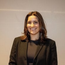 headshot of Izzy Grable in a black shirt and black blazer
