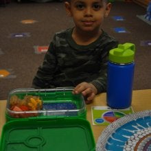 Child eating lunch with the lights out