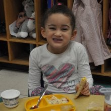 Child eating lunch with the lights out