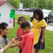 Children painting the Little Free Library