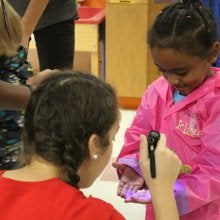 Checking to see germs using a special flash light.