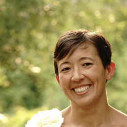 A female faculty with a short hair and wide smile. 