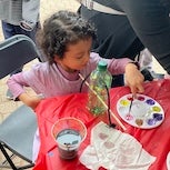 Girl painting bird feeder