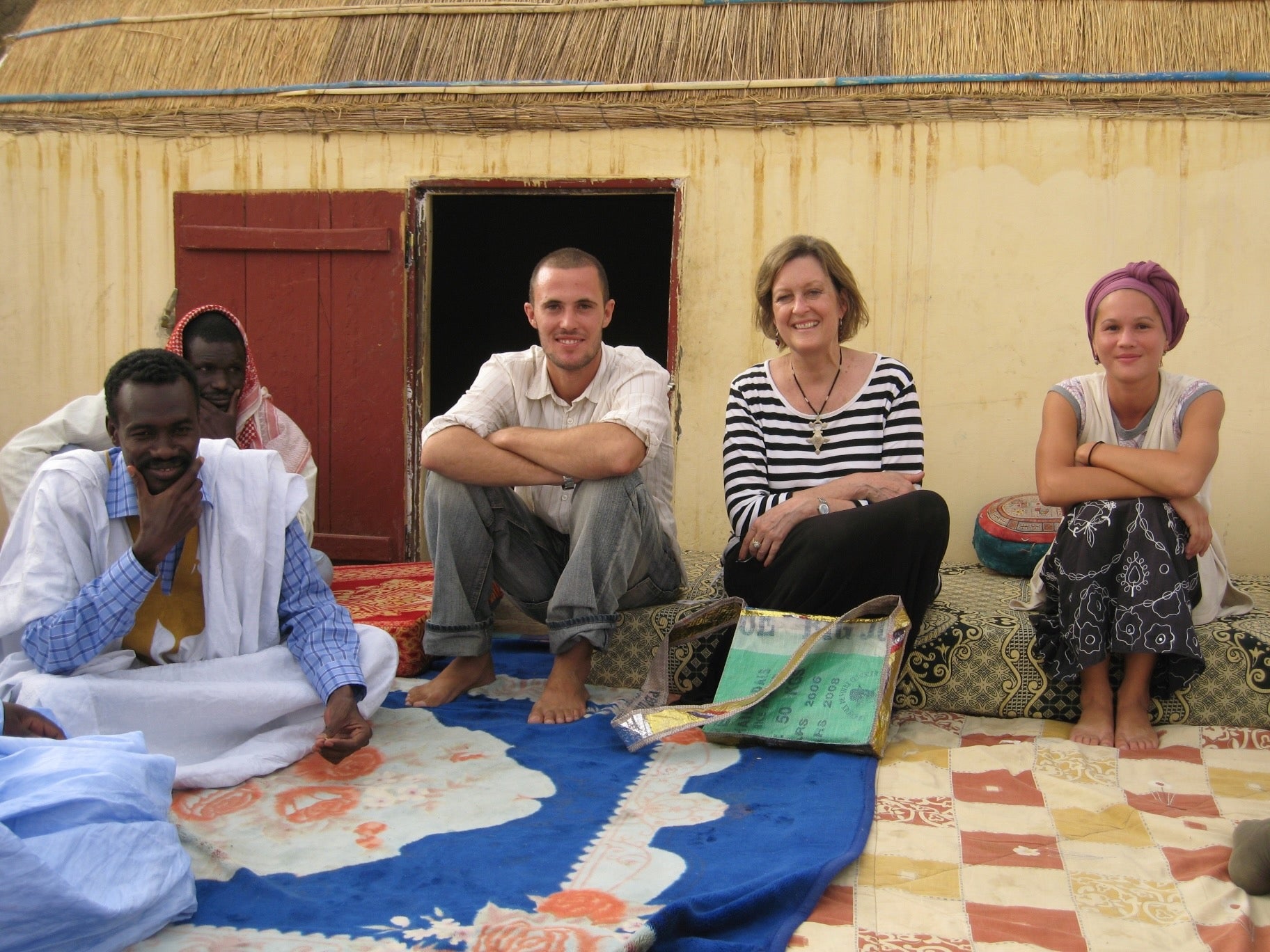 Jody Olsen Ph.D. '79 relaxes with local friends and Peace Corps volunteers in Senegal.