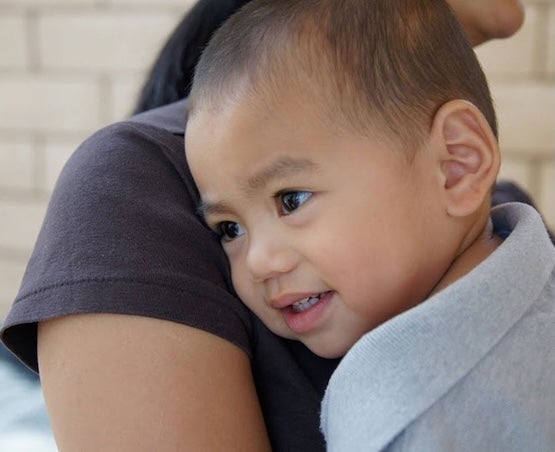 Caregiver comforts young child