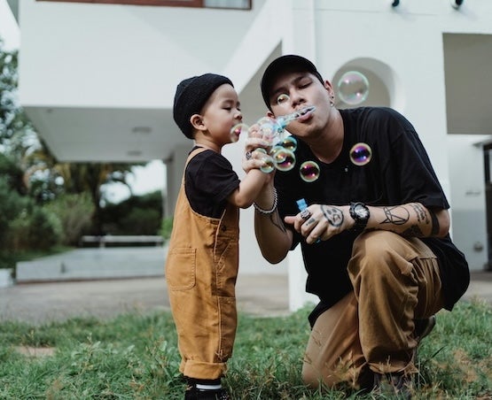 Father and son blowing bubbles