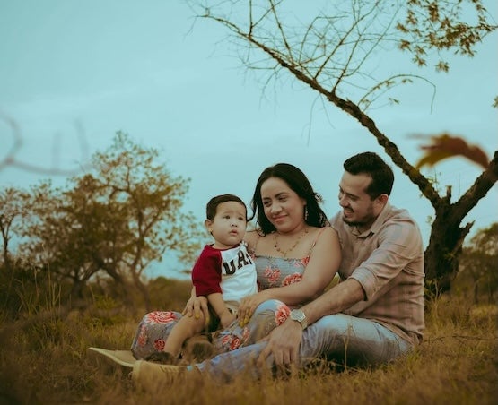 Parents and child sitting outdoors