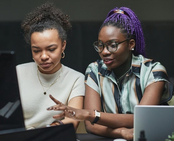 Two women collaborating at office desk