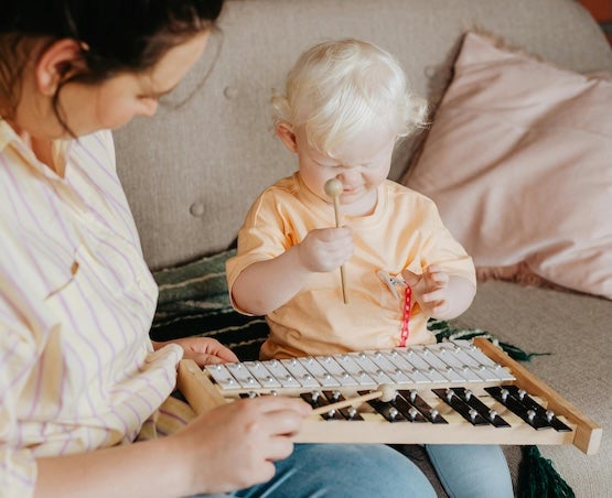 Woman and child playing xylophone