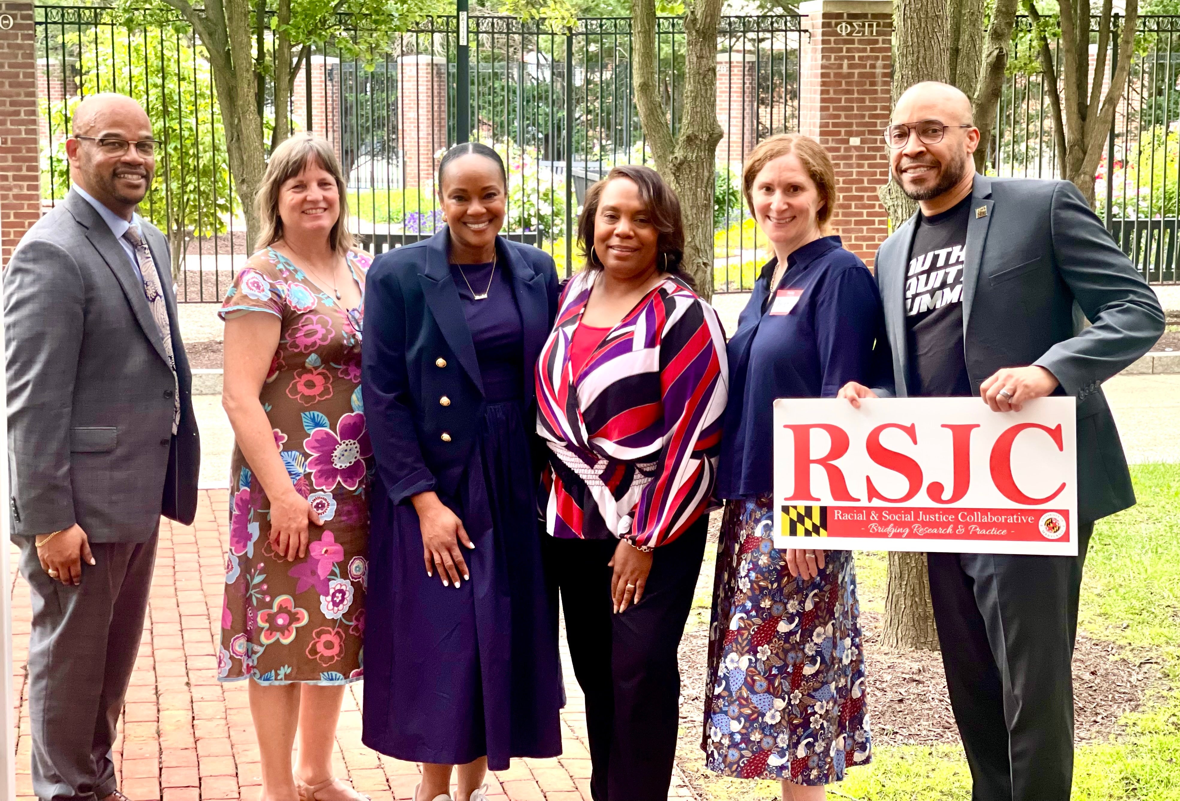 Group standing with a sign that says RSJC