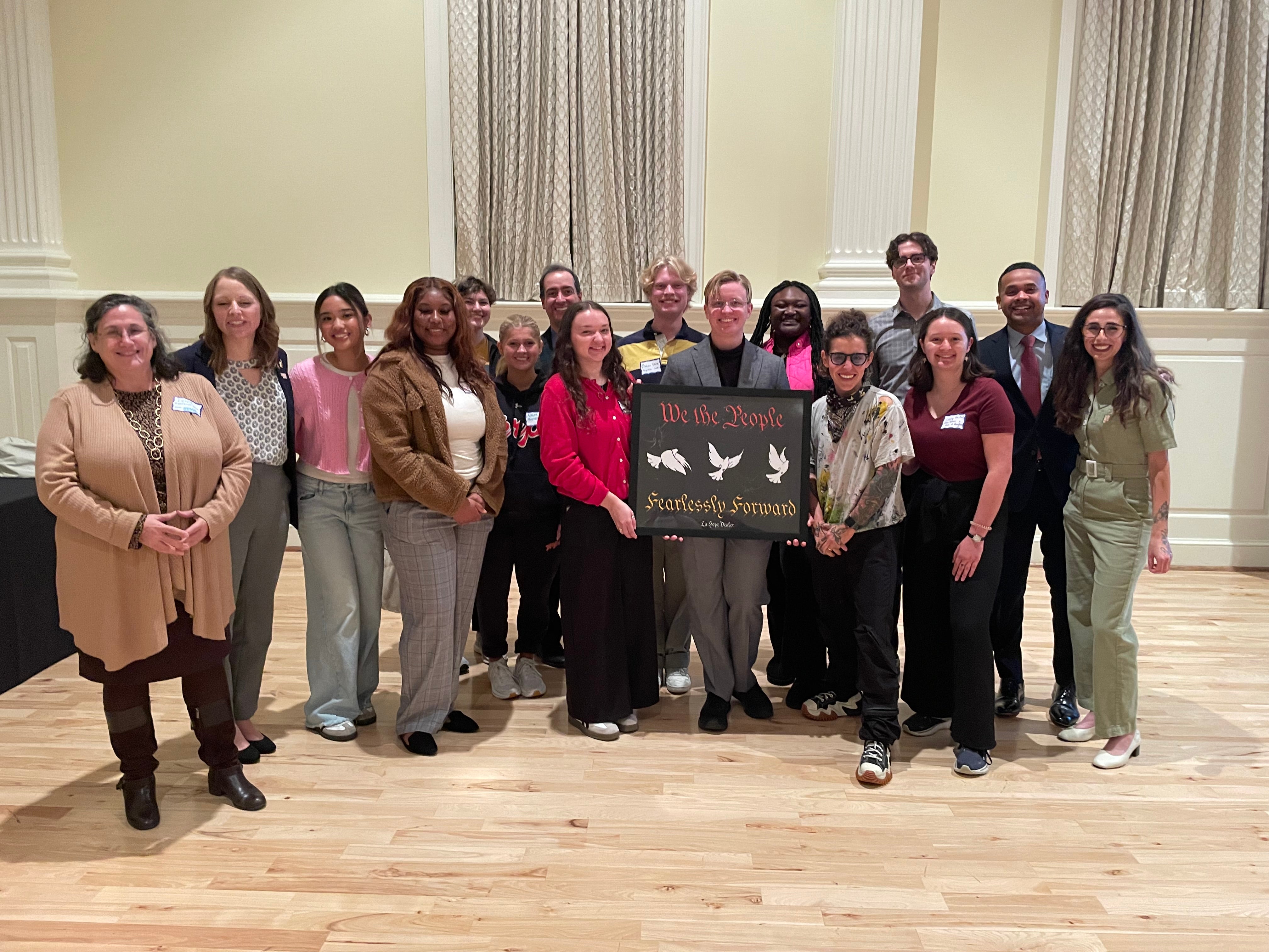 Group holding a sign at 2024 National Student Vote Summit that says "We the People: Fearlessly Forward"