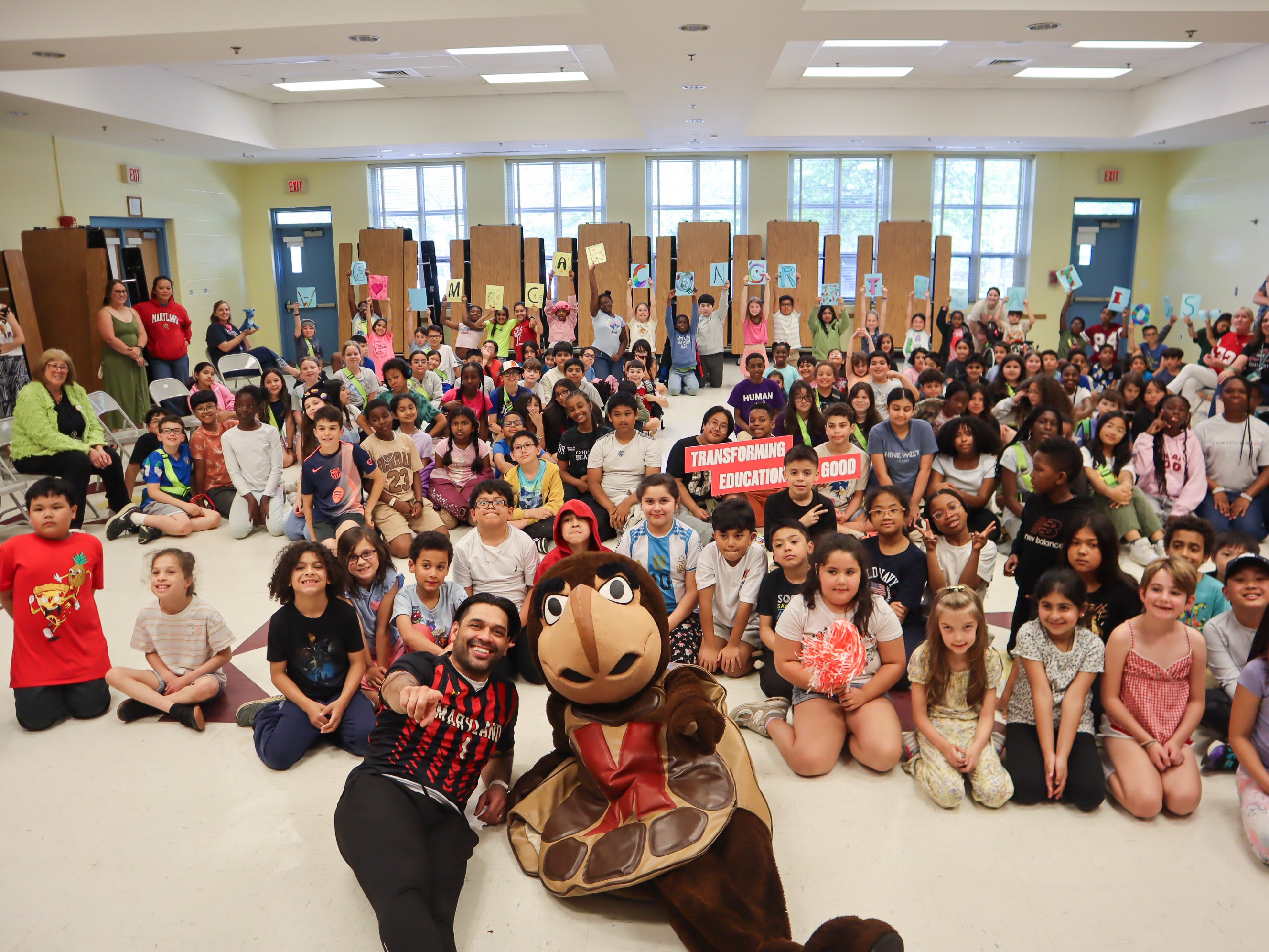 Testudo and the students of Mill Creek Towne Elementary School celebrate P.E. teacher Sergio Cabrera ’14, M.Ed. ’17 during a surprise school assembly for Teacher Appreciation Week.