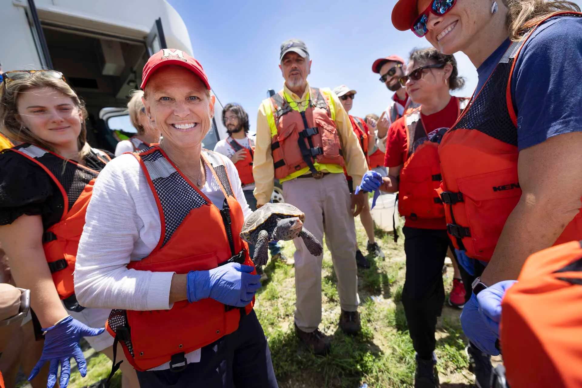 Provost and Senior Vice President Jennifer King Rice holds a wild adult female terrapin, captured by scientists on Poplar Island for tagging.