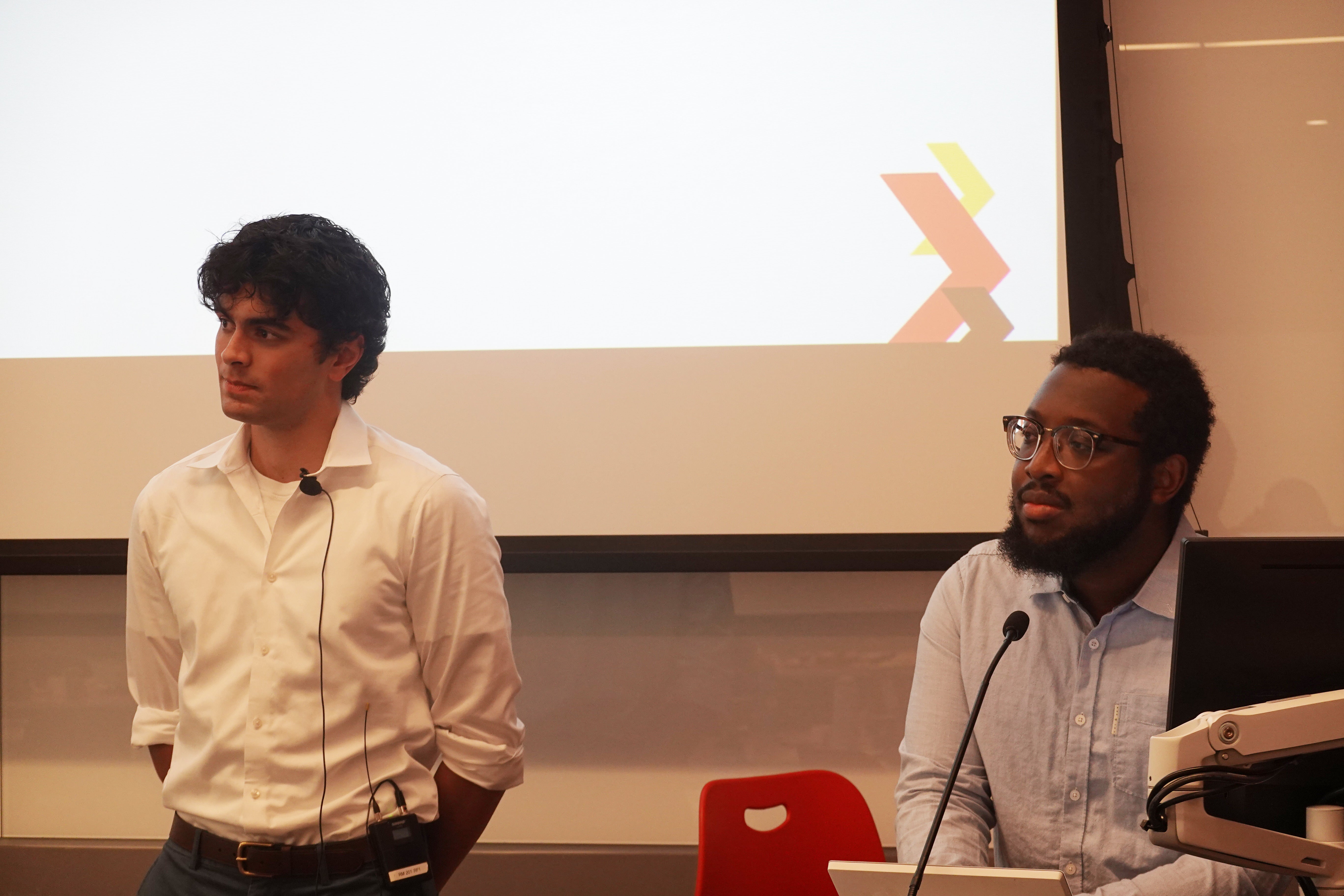 Anderson Harlor ’29 and Keith Ferguson of TerpsVote stand in front a screen getting ready to present to UMD instructors.
