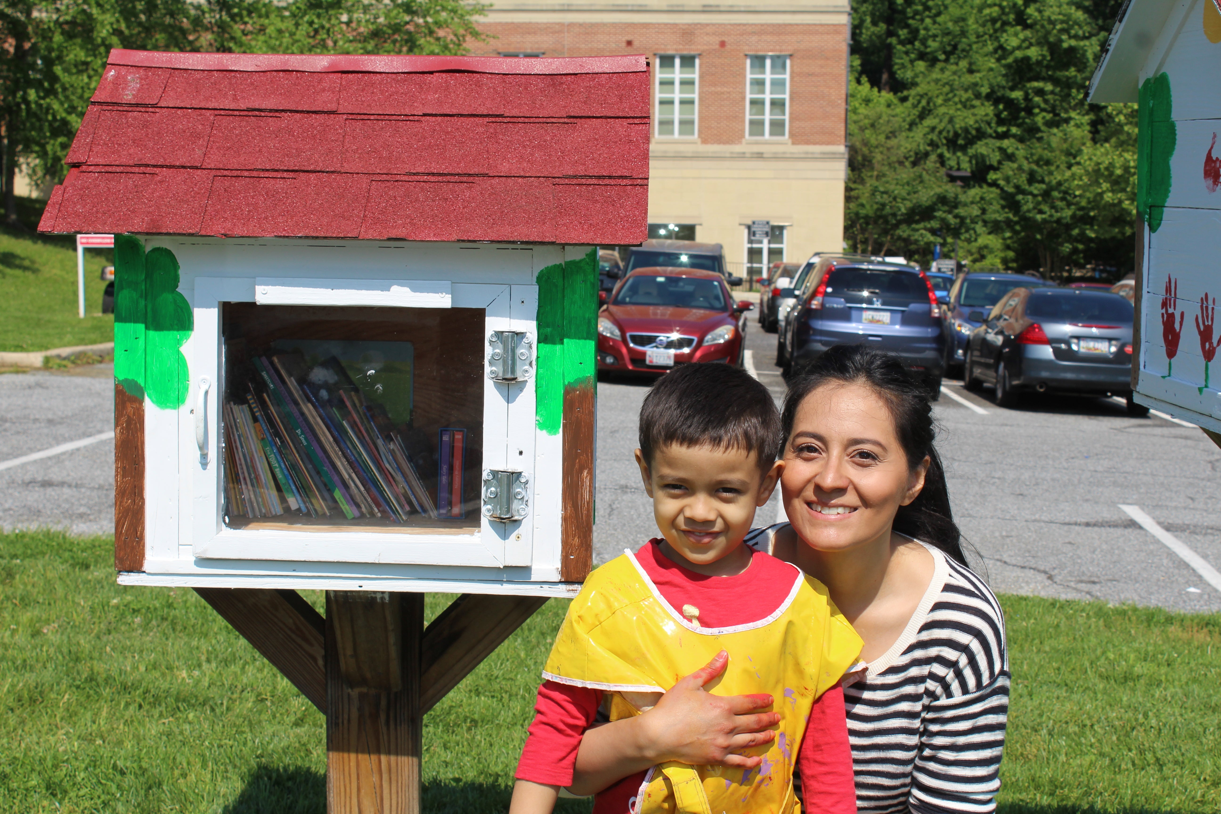mother and son in front of the little free library