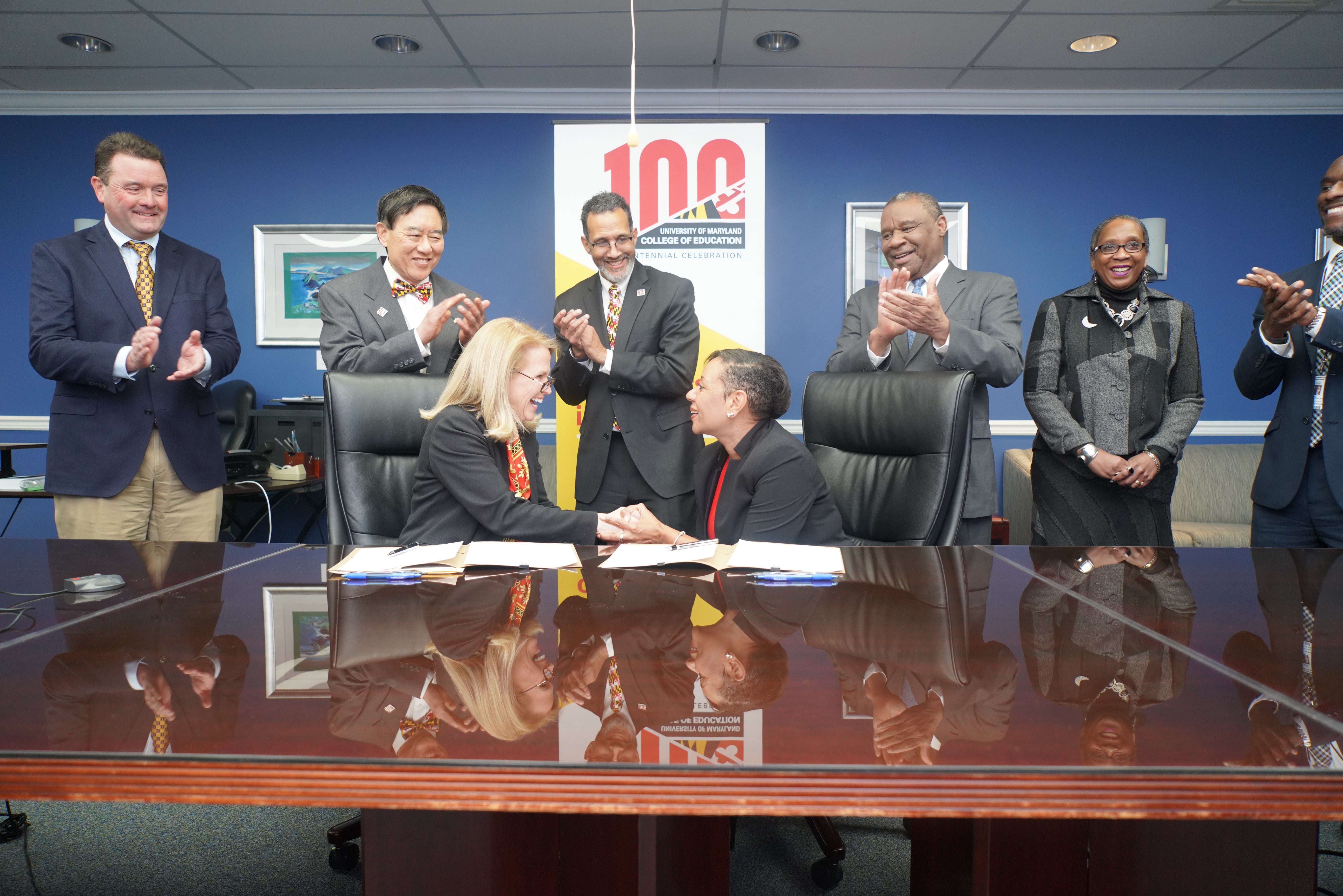 Dean Rice and PGCPS CEO Monica Goldstone shake hands at MOU signing.