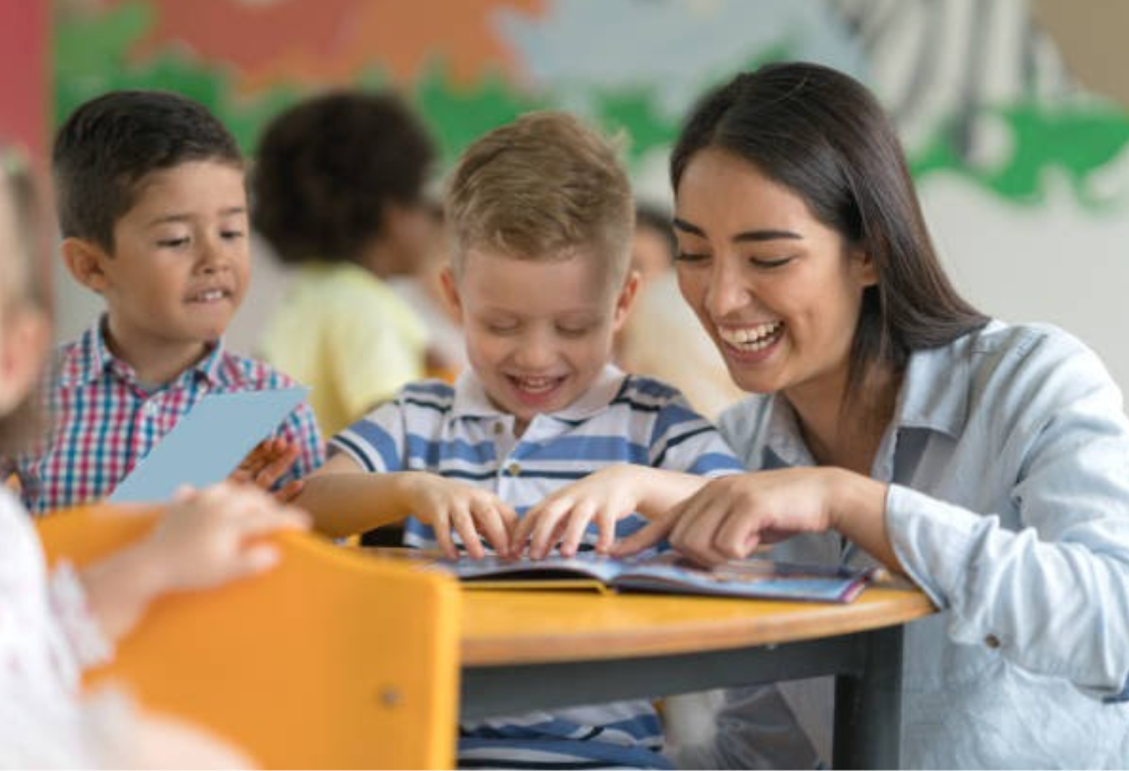 Elementary teacher with children reading